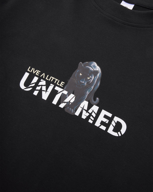 Untamed tee front graphic detail on black cotton fabric – close-up