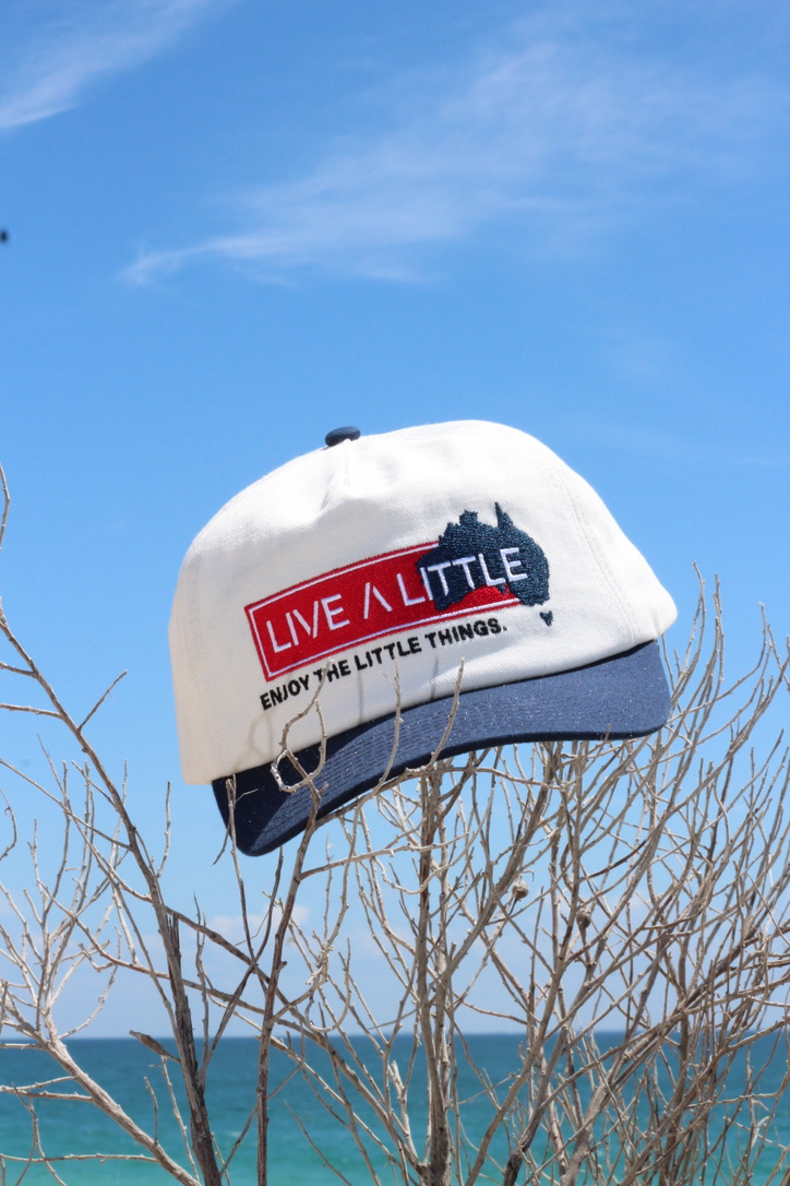 Homeland Cap embroidered logo detail on white and navy cap