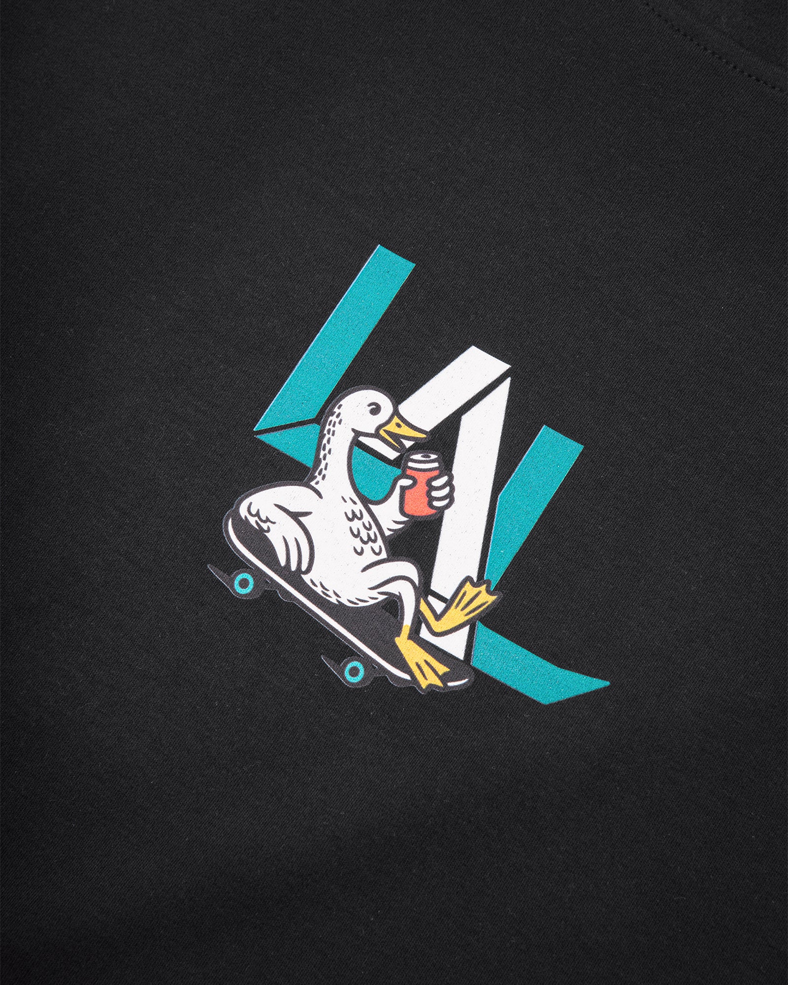 Goose Juice tee front graphic detail on black cotton fabric – close-up